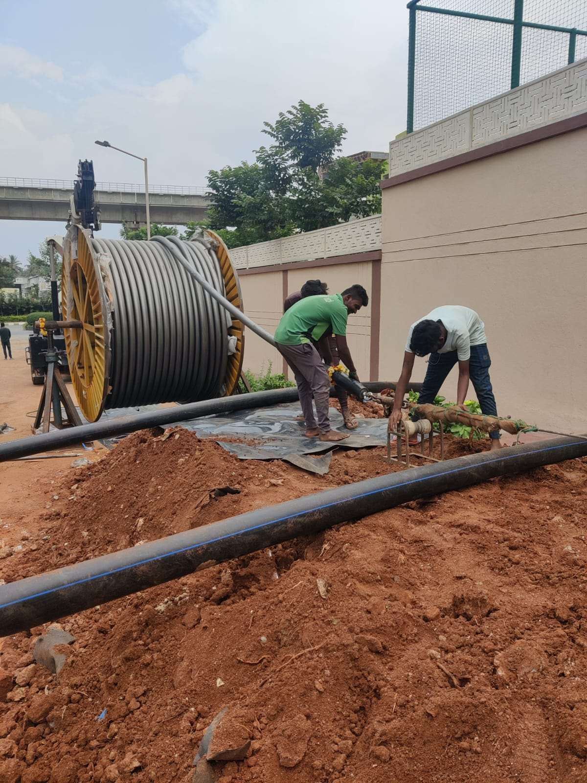 Crew pulling high-voltage cable on site
